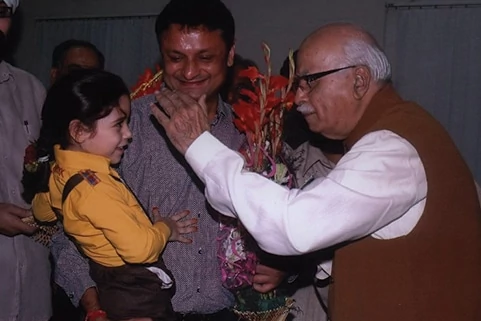 Shri L. K. Advani in a playful mood with a student from Shemrock School